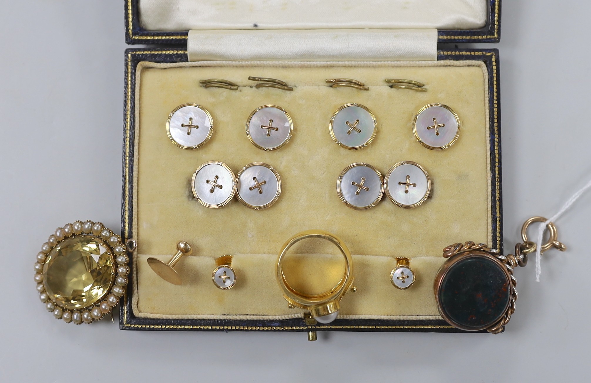 A late Victorian yellow metal, citrine and split pearl cluster set oval pendant brooch, 36mm, a Greek 875 yellow metal and simulated pearl ring, a chalcedony set spinning fob seal, a cased 9ct and mother of pearl eight p
